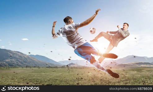 Businessman play ball. Young businessman in suit playing football with players outdoors