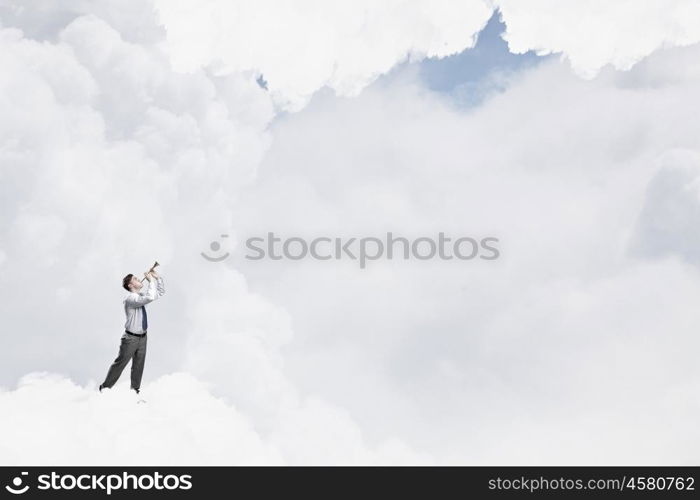 Businessman play pipe. Young businessman on cloud in sky playing pipe