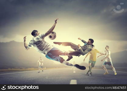 Businessman playing ball. Young businessman in suit playing football outdoors