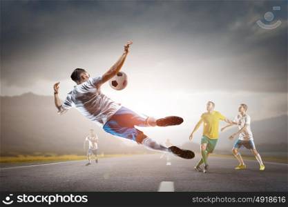 Businessman playing ball. Young businessman in suit playing football outdoors