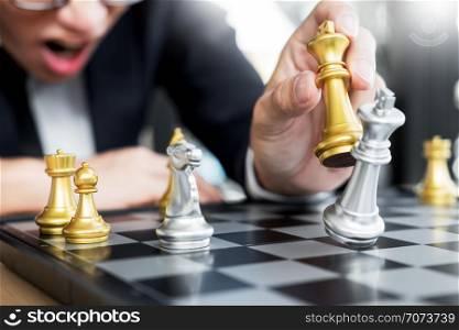 businessman playing chess figure take a checkmate another king with team, strategy or management win or success concept