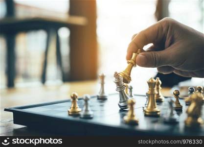 Businessman playing chess game beat opponent with strategy concept.