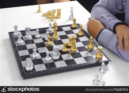 Businessman playing chess game; business strategy, leadership and management concept.