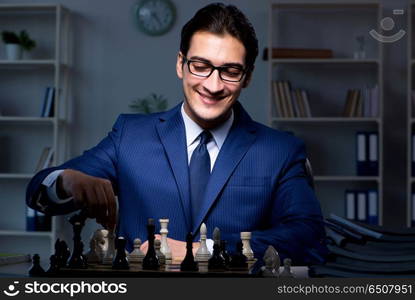 Businessman playing chess in strategy concept