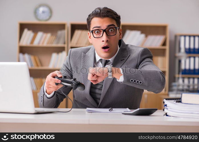 Businessman playing computer games at work office