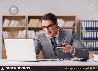 Businessman playing computer games at work office