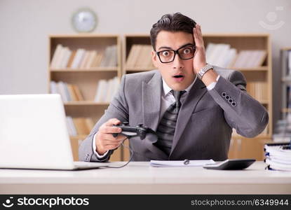 Businessman playing computer games at work office