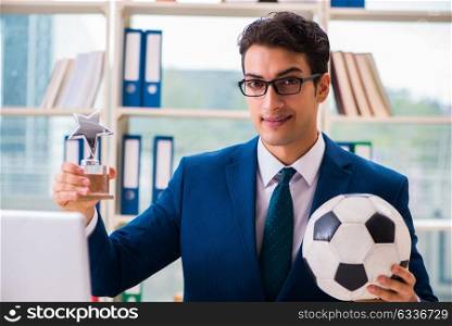 Businessman playing football in the office