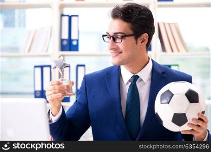 Businessman playing football in the office