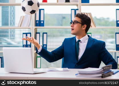 Businessman playing football in the office