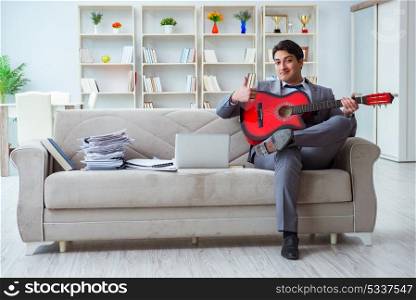 Businessman playing guitar at home
