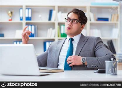 Businessman playing virtual guitar in office