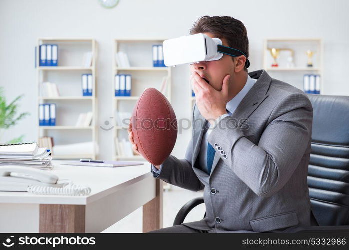 Businessman playing virtual reality football in office with VR goggle. Businessman playing virtual reality football in office with VR g