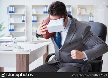 Businessman playing virtual reality football in office with VR goggle. Businessman playing virtual reality football in office with VR g