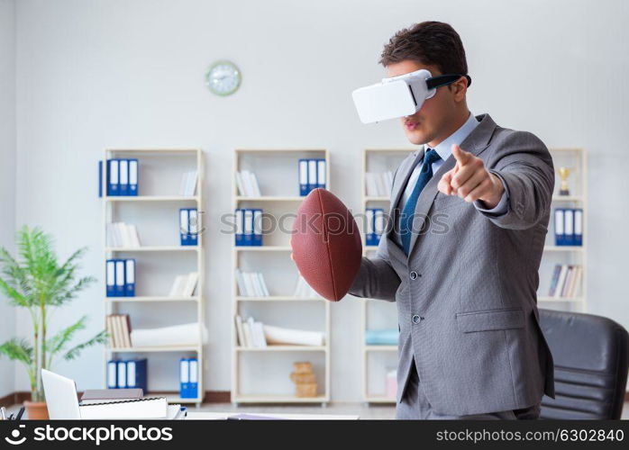 Businessman playing virtual reality football in office with VR goggle. Businessman playing virtual reality football in office with VR g