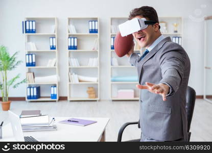 Businessman playing virtual reality football in office with VR goggle. Businessman playing virtual reality football in office with VR g