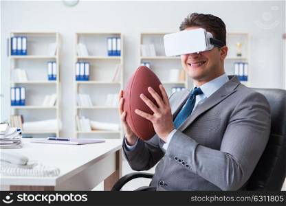 Businessman playing virtual reality football in office with VR goggle. Businessman playing virtual reality football in office with VR g