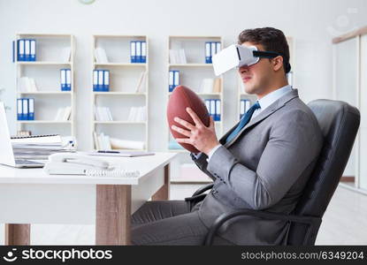 Businessman playing virtual reality football in office with VR goggle. Businessman playing virtual reality football in office with VR g