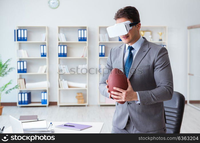 Businessman playing virtual reality football in office with VR goggle. Businessman playing virtual reality football in office with VR g