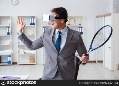 Businessman playing virtual reality tennis in office with VR goggle. Businessman playing virtual reality tennis in office with VR gog