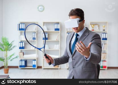 Businessman playing virtual reality tennis in office with VR goggle. Businessman playing virtual reality tennis in office with VR gog