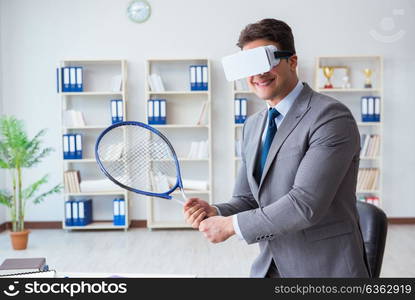 Businessman playing virtual reality tennis in office with VR goggle. Businessman playing virtual reality tennis in office with VR gog