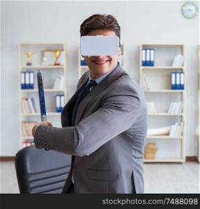 Businessman playing virtual reality tennis in office with VR goggle. Businessman playing virtual reality tennis in office with VR gog