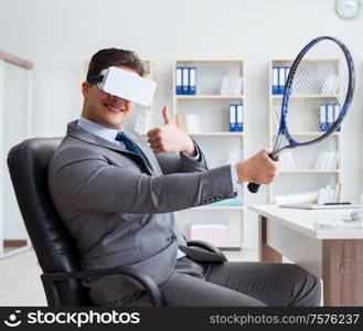 Businessman playing virtual reality tennis in office with VR goggle. Businessman playing virtual reality tennis in office with VR gog