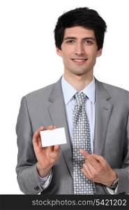 Businessman pointing at blank card