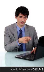 Businessman pointing at laptop screen