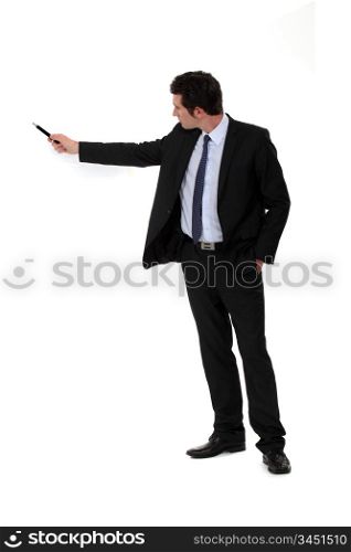 businessman pointing at something with his pen