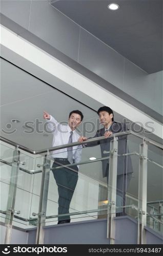 Businessman Pointing by Rail