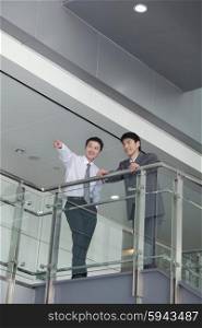 Businessman Pointing by Rail