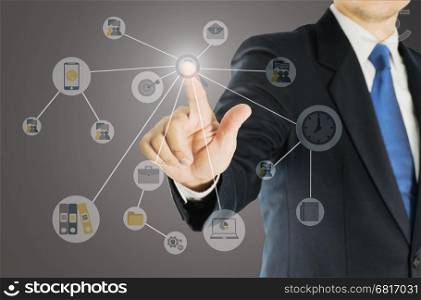 Businessman pointing out with business icons overlay