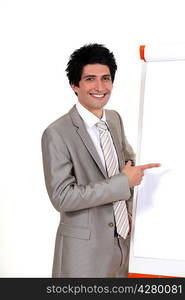 Businessman pointing to a flip chart