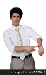 Businessman pointing to his watch
