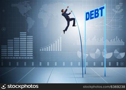 Businessman pole vaulting over debt in business concept
