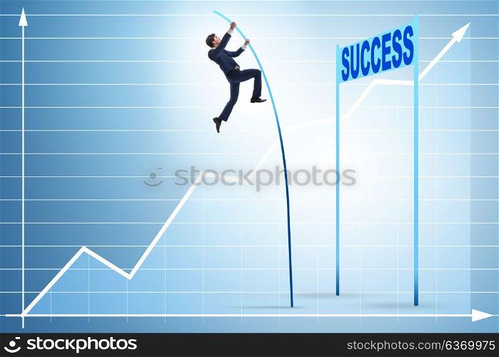 Businessman pole vaulting over towards his success career