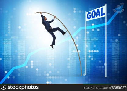 Businessman pole vaulting towards his goal in business concept