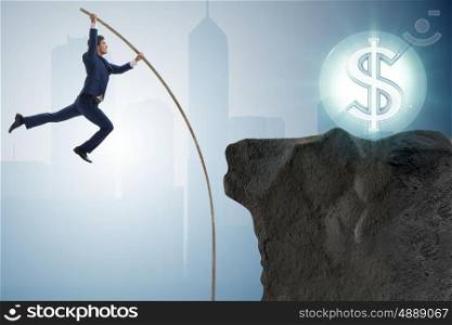 Businessman pole vaulting towards his money goal. The businessman pole vaulting towards his money goal