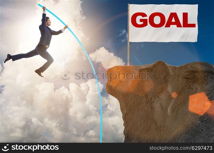 Businessman pole vaulting towards his success goal. The businessman pole vaulting towards his success goal