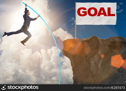 Businessman pole vaulting towards his success goal. The businessman pole vaulting towards his success goal