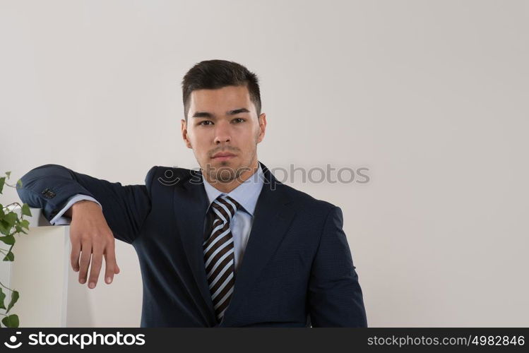 Businessman portrait standing calm and thoughtful at office