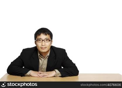 Businessman posing in an office, with copy space