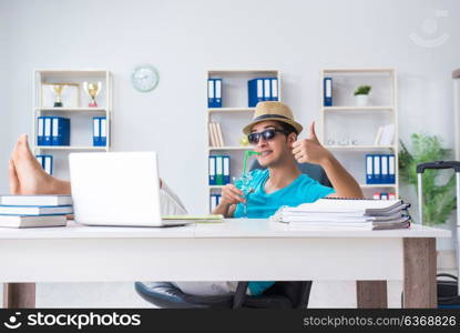 Businessman preparing for vacation in the office