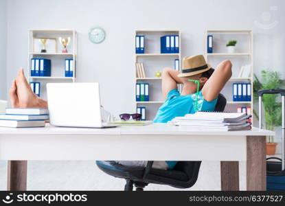 Businessman preparing for vacation in the office