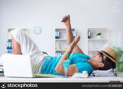 Businessman preparing for vacation in the office