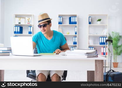 Businessman preparing for vacation in the office