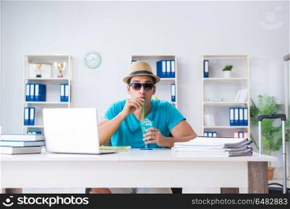 Businessman preparing for vacation in the office