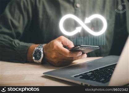 Businessman presents smartphone with infinity symbol, signifying limitless connection in data technology, future unlimited. Infinite power, energy, internet information. technology infinity data